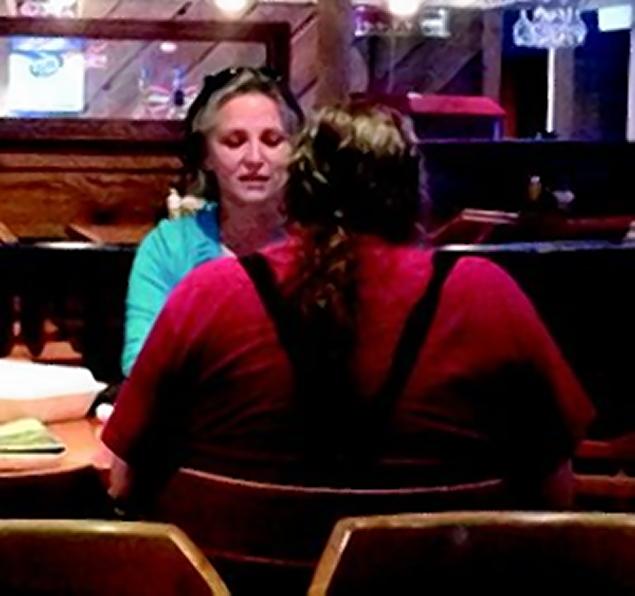 Reporter Ann Marie Gardner of the Georgetown Advocate speaking to Dr. James St. James at a restaurant near the Millikin University campus.