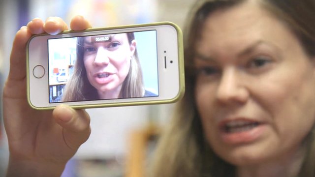 A woman holding up a camera Selfie