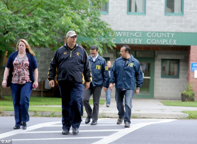 Somber: DA Mary Rain, left, said she expected more charges to be filed against the couple. She is pictured with county Sheriff Kevin M. Wells, who has noted just how much the incident has shaken the community