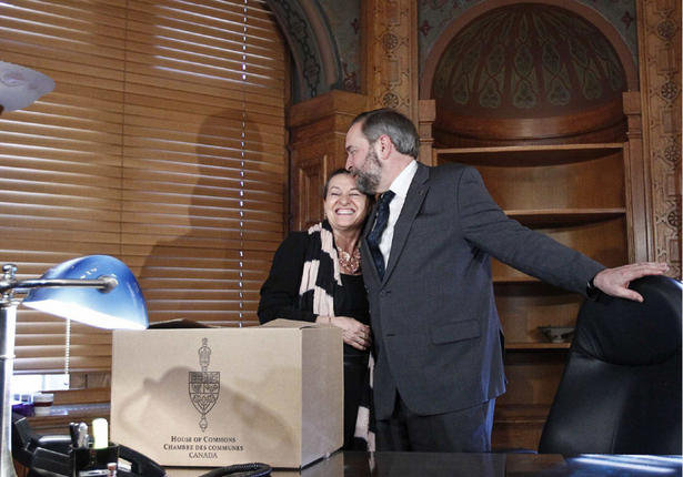 New Democratic Party leader Thomas Mulcair embraces his wife and confidant Catherine while moving into his new office on Parliament Hill last month after his election within the party.